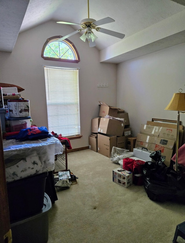 carpeted bedroom with a ceiling fan and lofted ceiling