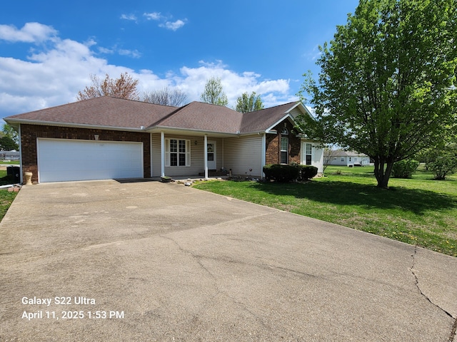 ranch-style house with concrete driveway, a garage, a front lawn, and brick siding