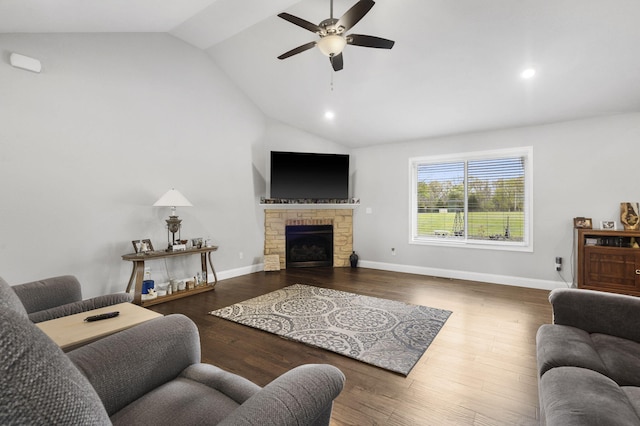 1758 W Big Meadows Ln, Nixa, MO 65714 - living area with baseboards, a stone fireplace, a ceiling fan, wood finished floors, and vaulted ceiling