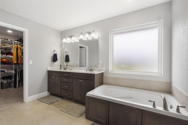 1758 W Big Meadows Ln, Nixa, MO 65714 - full bathroom with double vanity, tile patterned flooring, a walk in closet, a bath, and a sink
