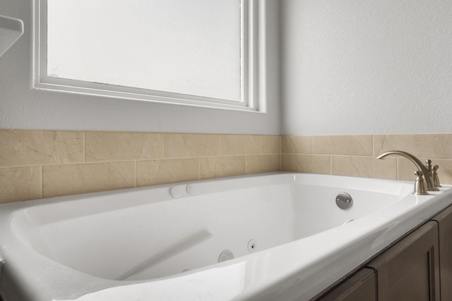 1758 W Big Meadows Ln, Nixa, MO 65714 - bathroom featuring a jetted tub and a textured wall