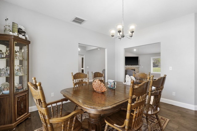1758 W Big Meadows Ln, Nixa, MO 65714 - dining area featuring dark wood-type flooring, visible vents, baseboards, and a chandelier