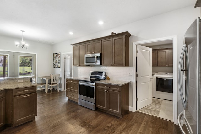 1758 W Big Meadows Ln, Nixa, MO 65714 - kitchen with a chandelier, dark brown cabinets, stainless steel appliances, backsplash, and washer / dryer