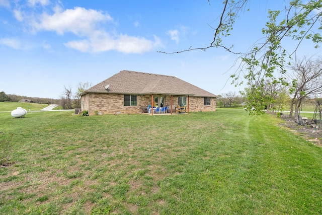1758 W Big Meadows Ln, Nixa, MO 65714 - rear view of house featuring brick siding and a lawn