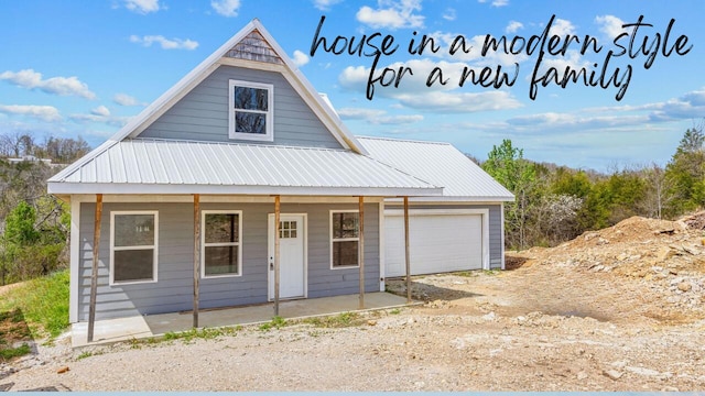 195 Fairsight Rd, Cape Fair, MO 65624 - view of front of home featuring covered porch, an attached garage, metal roof, and driveway