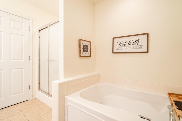 full bath featuring a shower stall, tile patterned flooring, and a bath