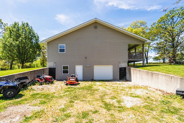 view of home's exterior featuring an attached garage, a yard, and driveway