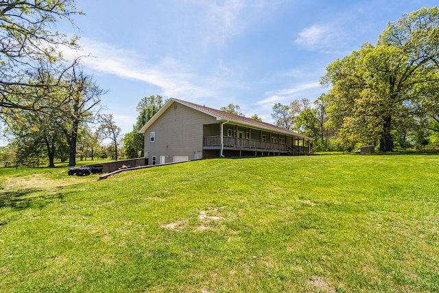 view of yard featuring an attached garage and a deck