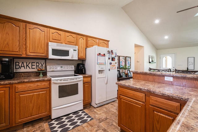 kitchen featuring white appliances, stone finish floor, brown cabinets, recessed lighting, and high vaulted ceiling