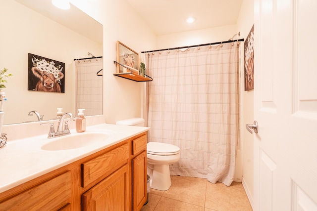 bathroom featuring toilet, tile patterned floors, vanity, and curtained shower