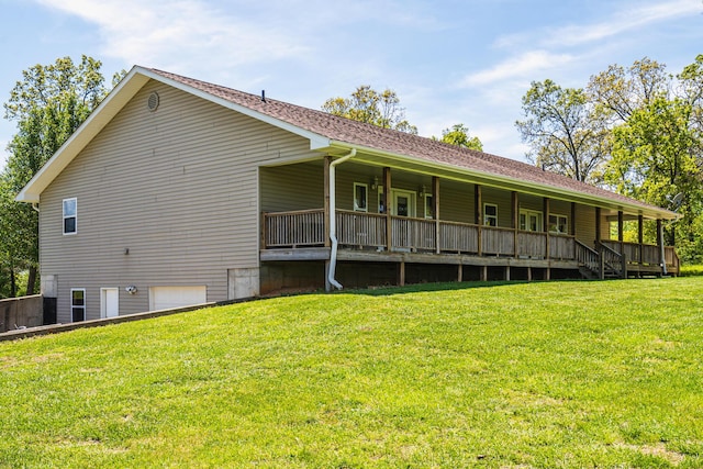 back of property with a yard and an attached garage
