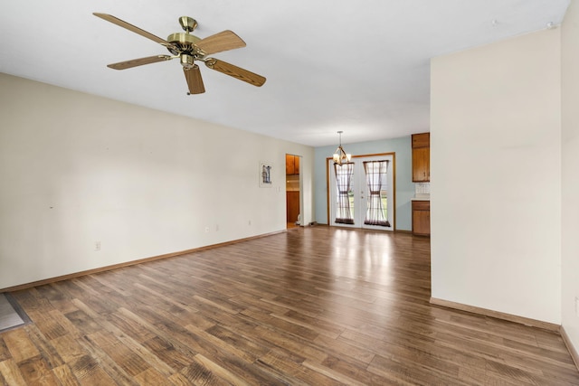3144 N Pierce Ave, Springfield, MO 65803 - unfurnished living room featuring wood finished floors, ceiling fan with notable chandelier, and baseboards