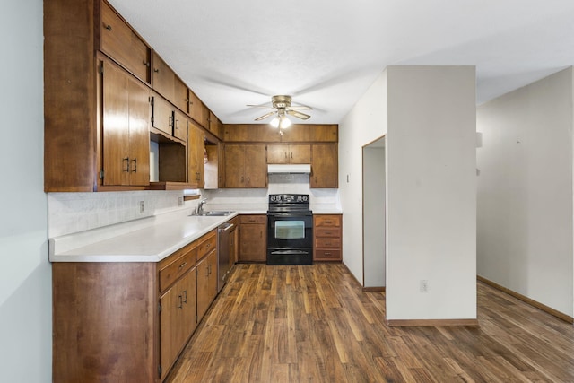 3144 N Pierce Ave, Springfield, MO 65803 - kitchen with stainless steel dishwasher, dark wood-type flooring, tasteful backsplash, under cabinet range hood, and black electric range oven