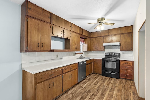 3144 N Pierce Ave, Springfield, MO 65803 - kitchen with tasteful backsplash, under cabinet range hood, dishwasher, a sink, and black electric range oven