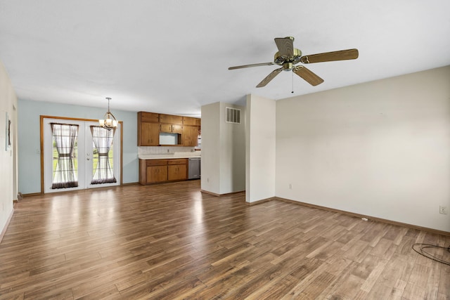 3144 N Pierce Ave, Springfield, MO 65803 - unfurnished living room with visible vents, ceiling fan with notable chandelier, baseboards, and dark wood-style floors