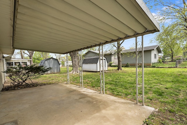 3144 N Pierce Ave, Springfield, MO 65803 - view of patio with a storage shed, fence, and an outbuilding
