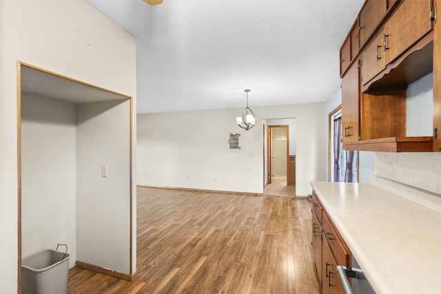 3144 N Pierce Ave, Springfield, MO 65803 - kitchen featuring brown cabinets, light countertops, light wood-style flooring, and baseboards