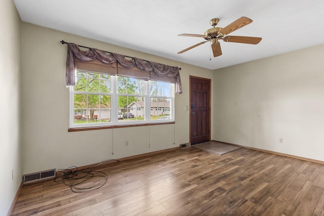 3144 N Pierce Ave, Springfield, MO 65803 - empty room featuring visible vents, ceiling fan, wood finished floors, and baseboards