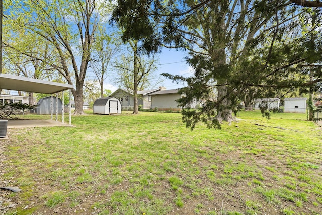 3144 N Pierce Ave, Springfield, MO 65803 - view of yard featuring a storage shed, fence, and an outbuilding