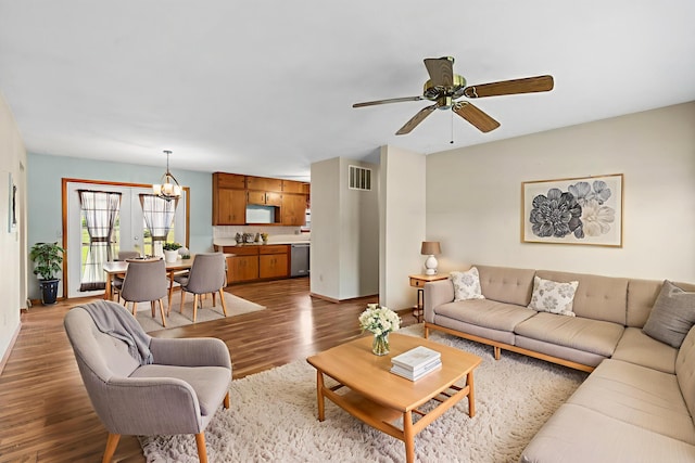 3144 N Pierce Ave, Springfield, MO 65803 - living area with a chandelier, ceiling fan, and wood finished floors