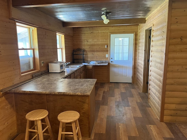 0 S 162nd Rd, Bolivar, MO 65613 - kitchen with a sink, a peninsula, dark wood finished floors, brown cabinetry, and a breakfast bar area