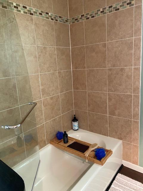 full bathroom featuring a shower and a tub to relax in