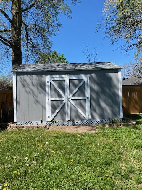 view of shed with fence