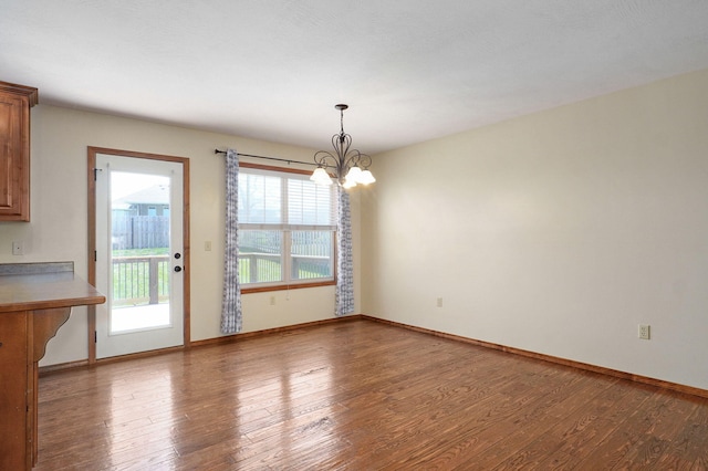 3684 Bridgewood Ave N, Springfield, MO 65803 - unfurnished dining area with wood finished floors, baseboards, and an inviting chandelier