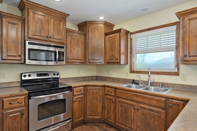 3684 Bridgewood Ave N, Springfield, MO 65803 - kitchen with brown cabinetry, appliances with stainless steel finishes, and a sink