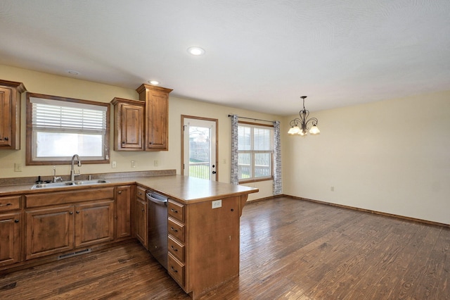 3684 Bridgewood Ave N, Springfield, MO 65803 - kitchen featuring stainless steel dishwasher, a sink, a peninsula, a notable chandelier, and dark wood-type flooring