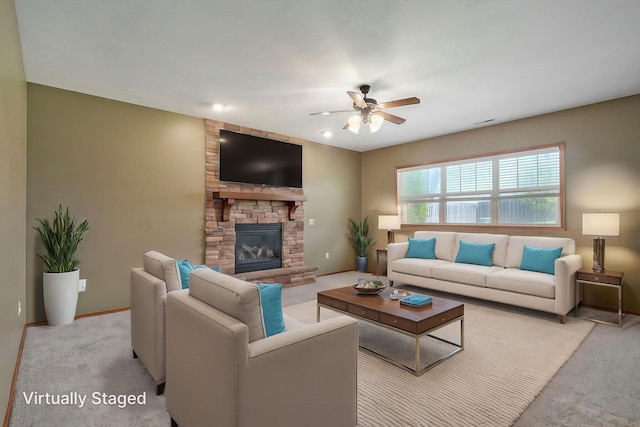 3684 Bridgewood Ave N, Springfield, MO 65803 - living room with carpet floors, a ceiling fan, a stone fireplace, and baseboards