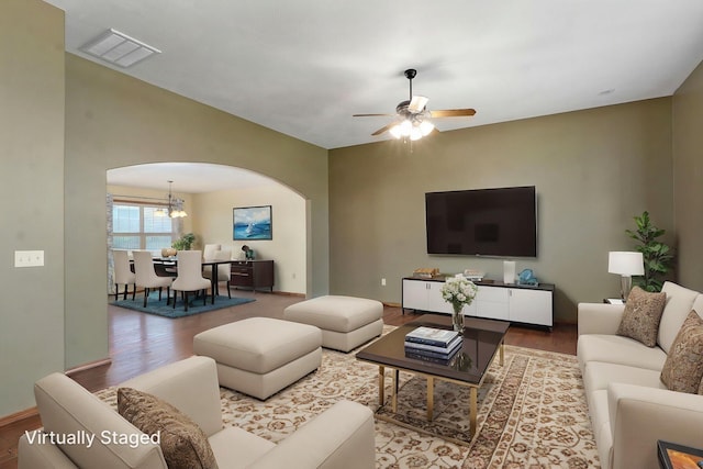 3684 Bridgewood Ave N, Springfield, MO 65803 - living room with wood finished floors, ceiling fan with notable chandelier, arched walkways, baseboards, and visible vents