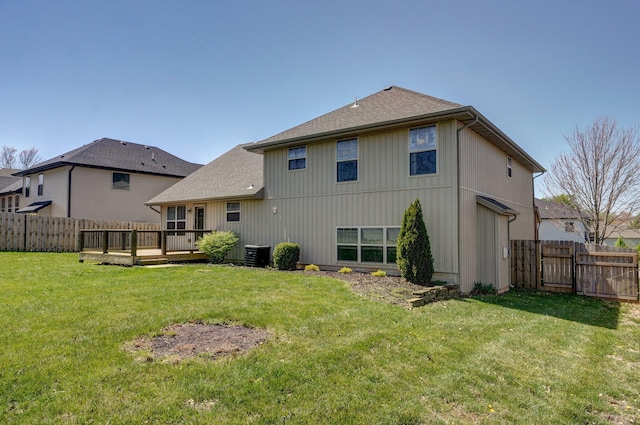 3684 Bridgewood Ave N, Springfield, MO 65803 - rear view of house with a fenced backyard, a yard, cooling unit, and a deck
