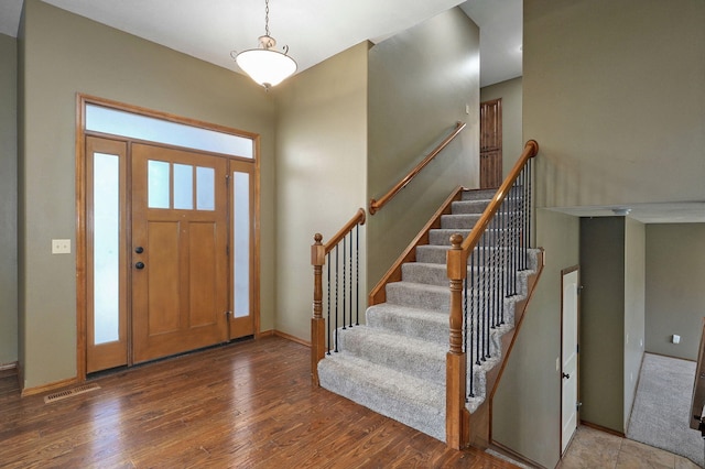 3684 Bridgewood Ave N, Springfield, MO 65803 - entrance foyer featuring baseboards, wood finished floors, visible vents, and stairs