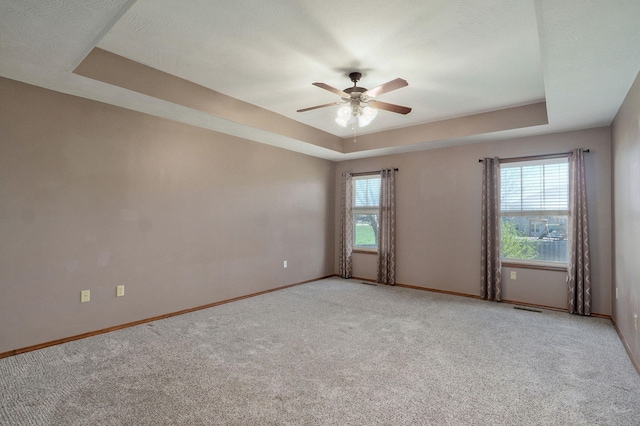 3684 Bridgewood Ave N, Springfield, MO 65803 - spare room with light colored carpet, baseboards, a ceiling fan, and a raised ceiling