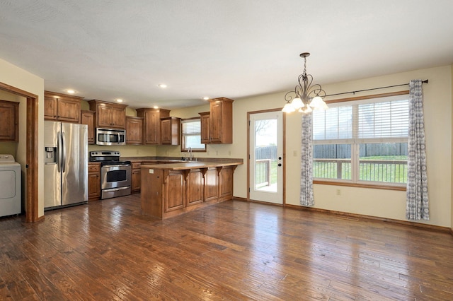 3684 Bridgewood Ave N, Springfield, MO 65803 - kitchen featuring a sink, an inviting chandelier, appliances with stainless steel finishes, a peninsula, and washer / clothes dryer