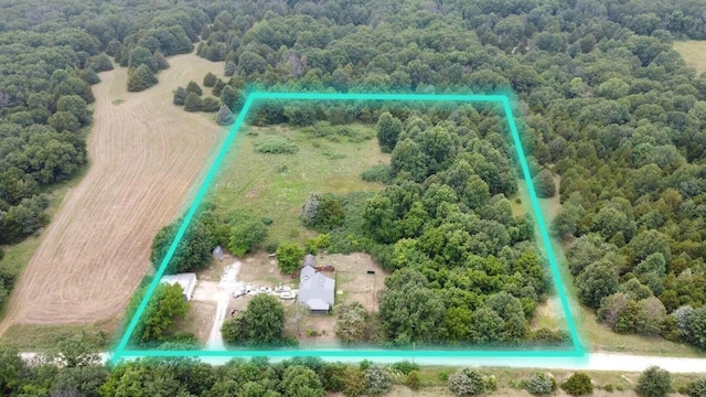 aerial view featuring a rural view and a wooded view