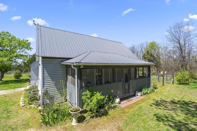 exterior space featuring a yard and metal roof