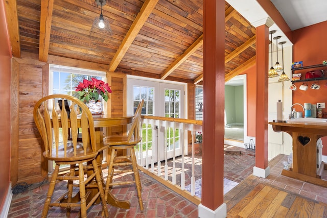 dining space with wood ceiling, vaulted ceiling with beams, and plenty of natural light