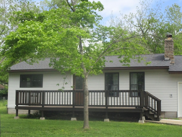 510 W 3rd St, Mountain View, MO 65548 - rear view of house with a wooden deck, a lawn, roof with shingles, and a chimney