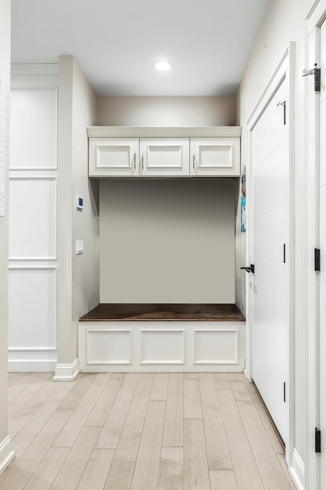 mudroom with light wood-type flooring, recessed lighting, and baseboards