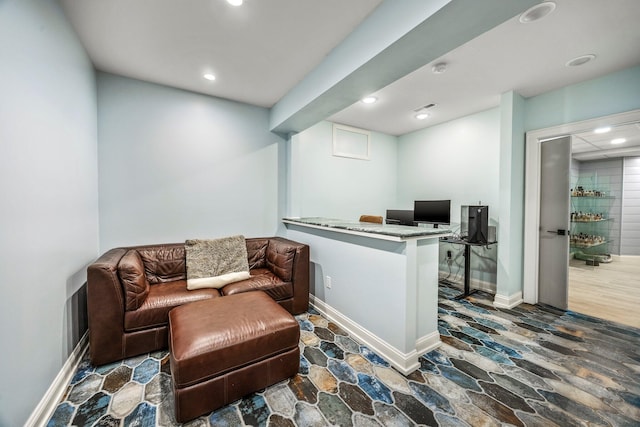interior space with stone finish floors, recessed lighting, a desk, and baseboards
