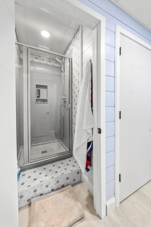 bathroom featuring a stall shower and wood finished floors