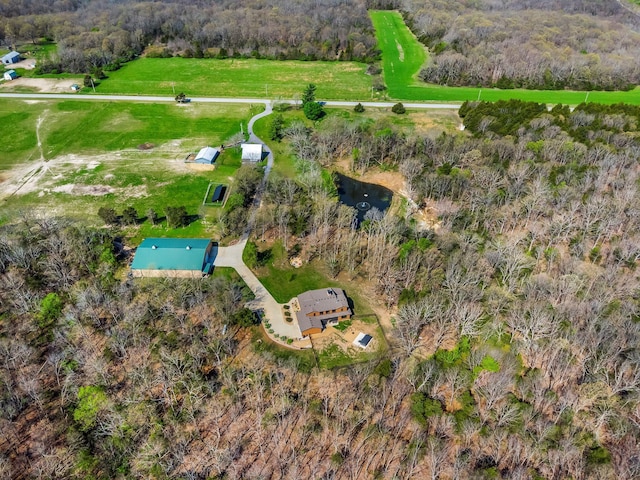 aerial view of property and surrounding area with a forest