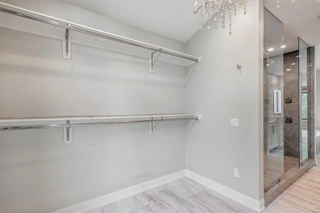 spacious closet with light marble finish floors