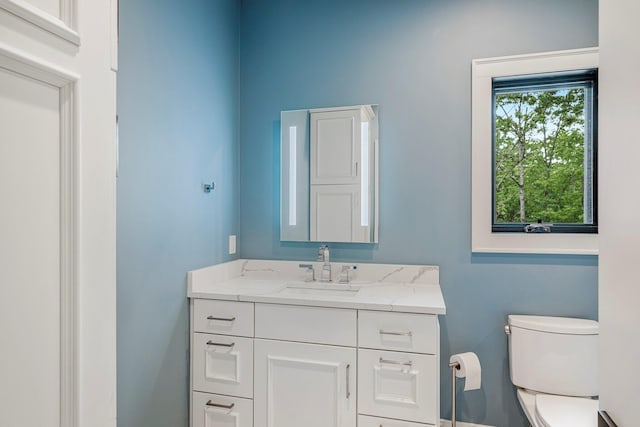 bathroom with toilet and vanity
