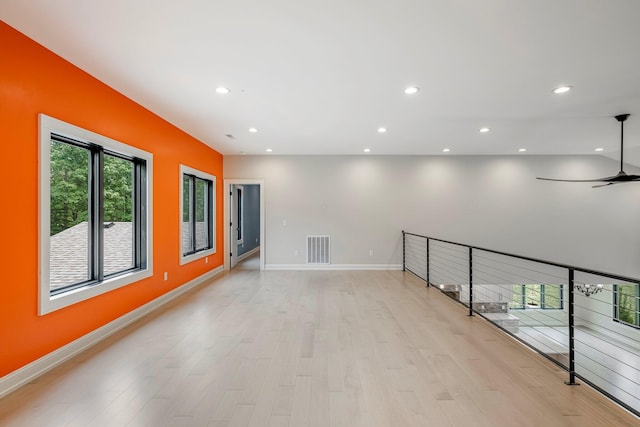 unfurnished room with light wood-type flooring, ceiling fan, baseboards, and recessed lighting