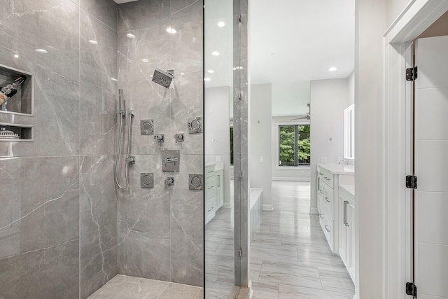 full bath featuring marble tiled floors, vanity, a walk in shower, recessed lighting, and a ceiling fan