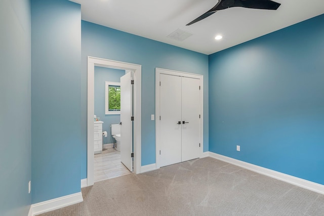 unfurnished bedroom featuring carpet floors, baseboards, a closet, recessed lighting, and ensuite bathroom