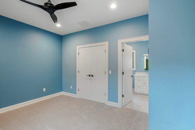unfurnished bedroom featuring light colored carpet, recessed lighting, baseboards, a closet, and a ceiling fan